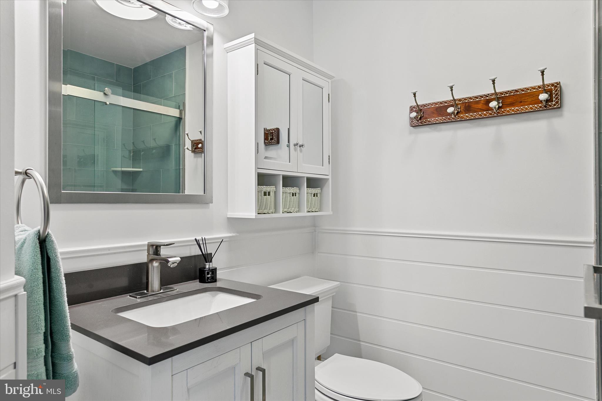 39655 Tie Breaker Court, Unit 4801 Bethany Beach, DE 19930 - Photo 29 of 58 a bathroom with a sink and a mirror