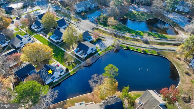 an aerial view of a house with a yard and lake view