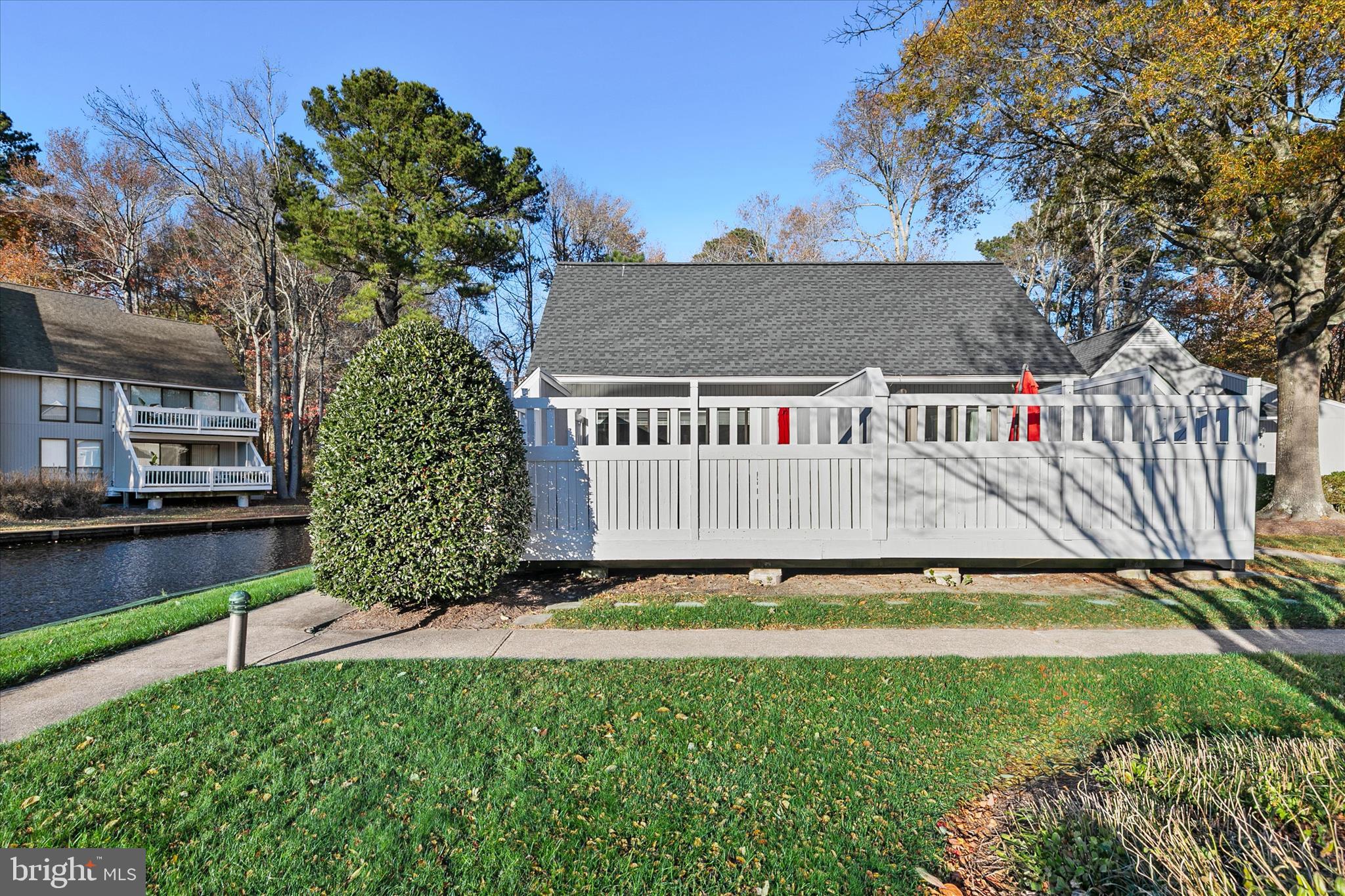 39655 Tie Breaker Court, Unit 4801 Bethany Beach, DE 19930 - Photo 8 of 58 a view of a house with garden and a bench
