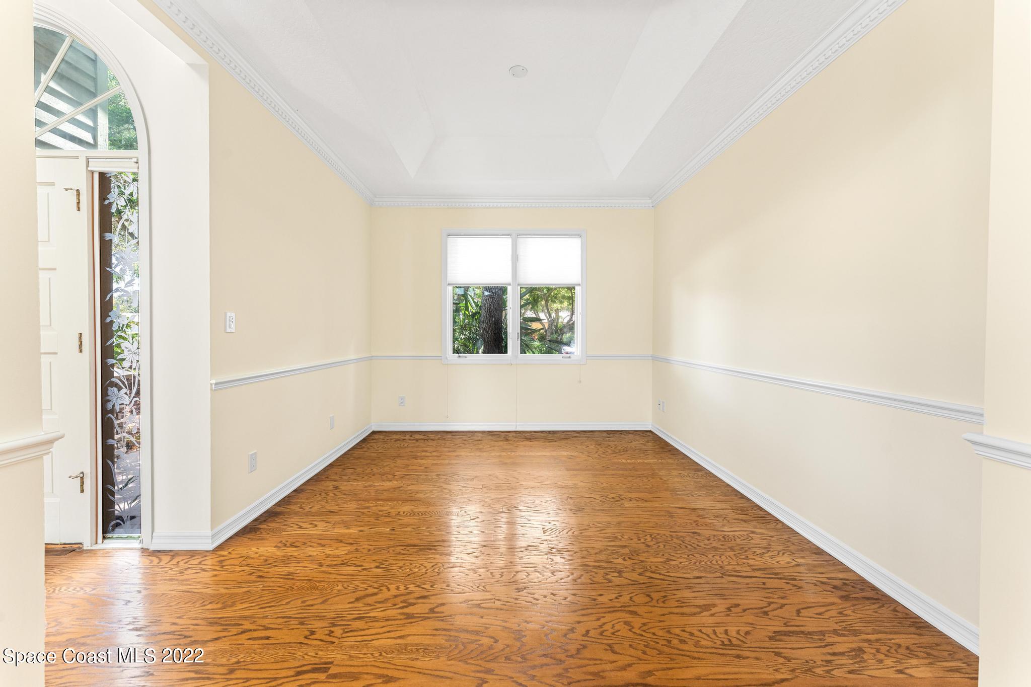 750 Kerry Downs Circle Melbourne, FL 32940 - Photo 11 of 34 a view of an empty room with wooden floor and a window