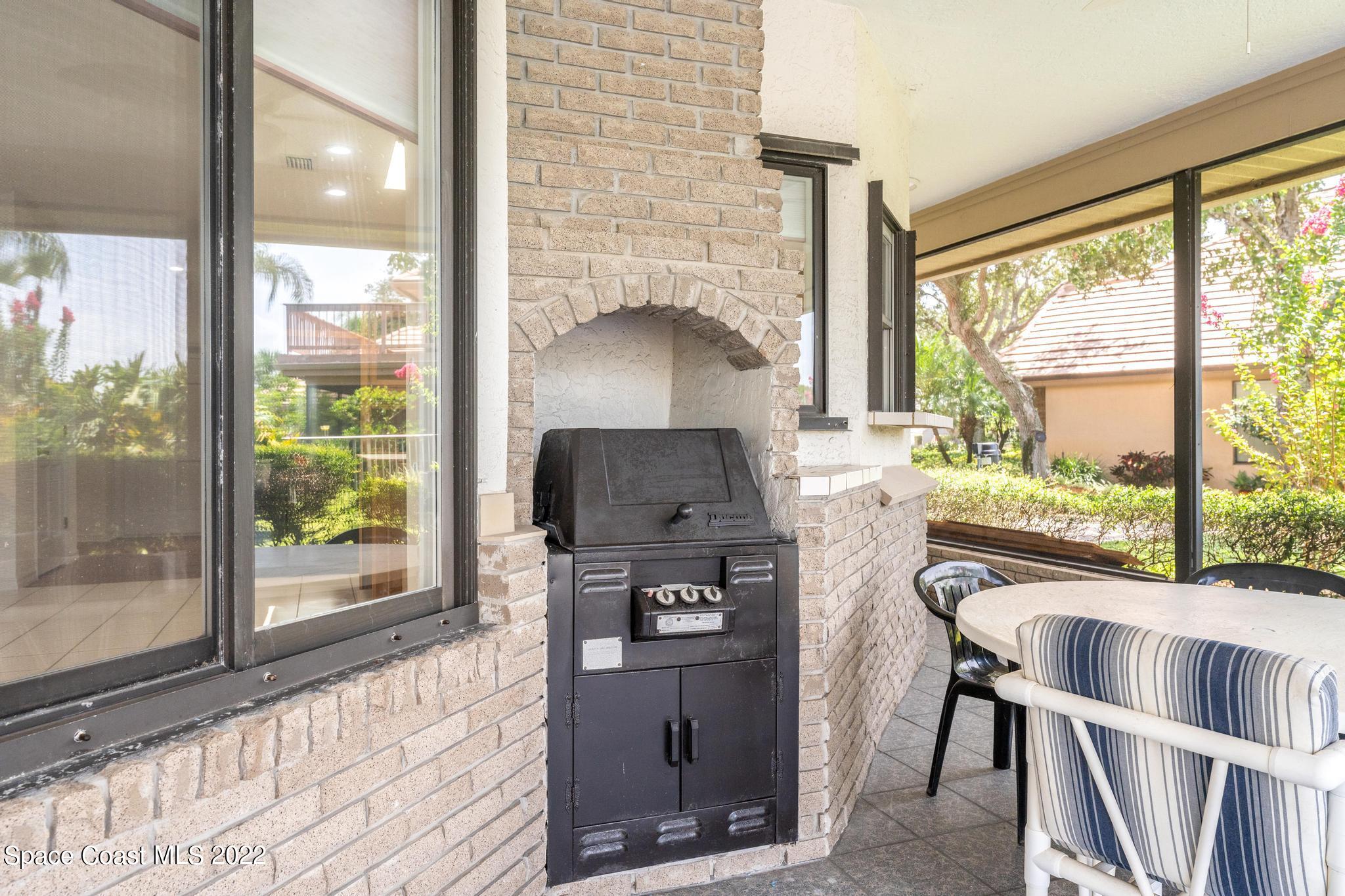 750 Kerry Downs Circle Melbourne, FL 32940 - Photo 20 of 34 a living room with furniture and a floor to ceiling window