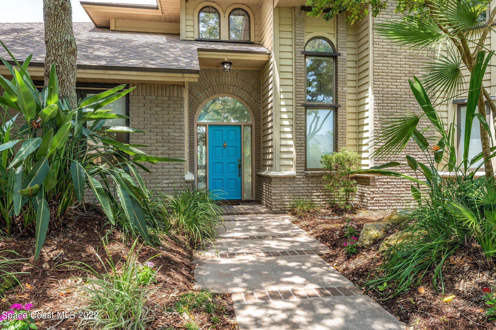 750 Kerry Downs Circle Melbourne, FL 32940 - Photo 2 of 34 a front view of a house with garden