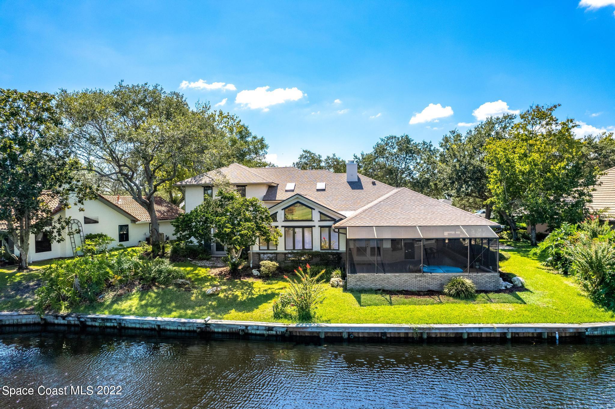750 Kerry Downs Circle Melbourne, FL 32940 - Photo 26 of 34 a view of a house with a yard and a large pool