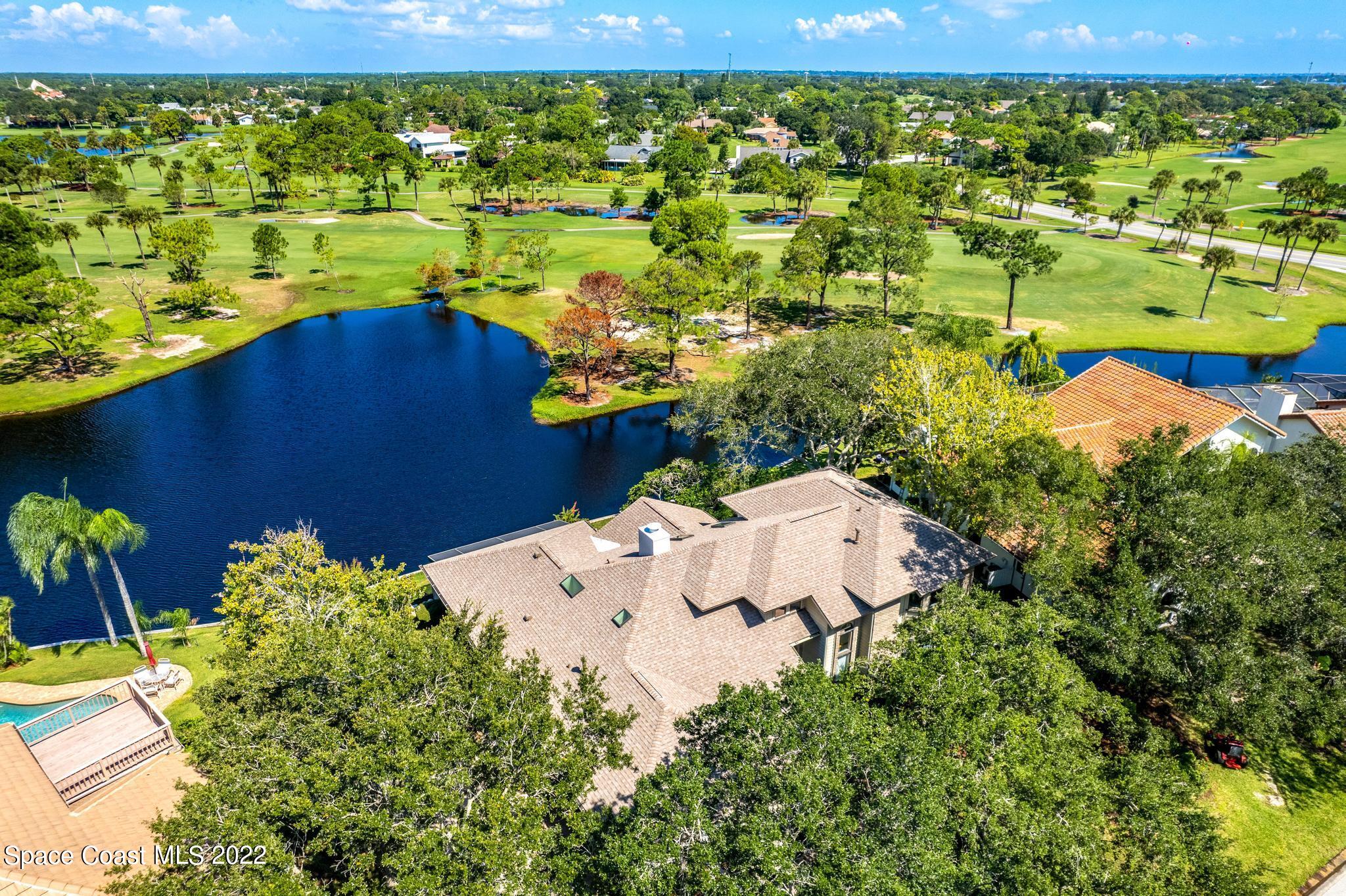 750 Kerry Downs Circle Melbourne, FL 32940 - Photo 30 of 34 a view of a lake with a houses