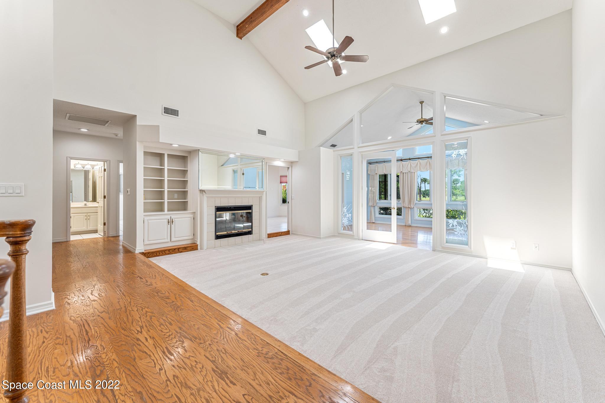 750 Kerry Downs Circle Melbourne, FL 32940 - Photo 3 of 34 a large bedroom with a large bed and a fireplace