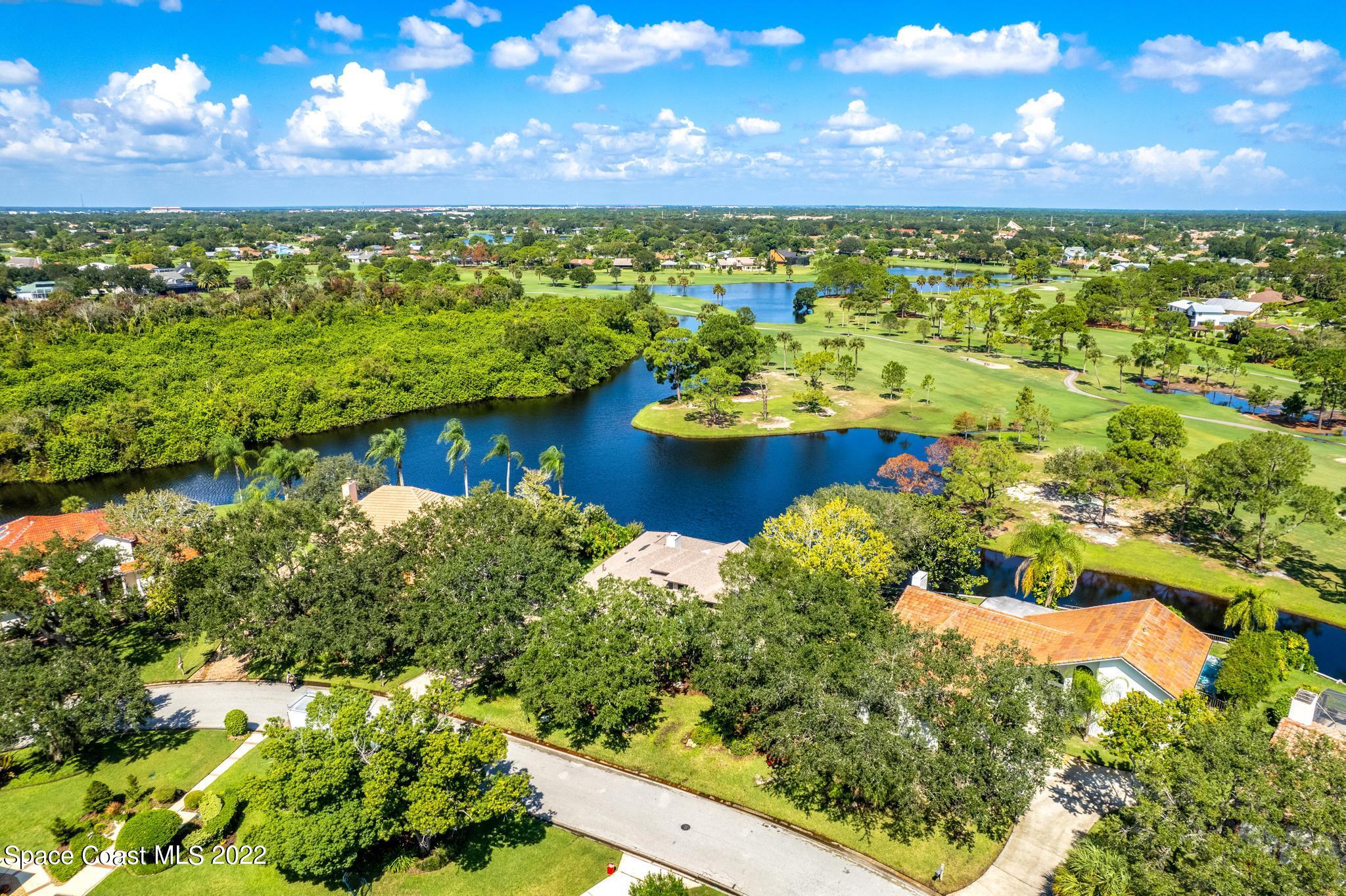 750 Kerry Downs Circle Melbourne, FL 32940 - Photo 31 of 34 a view of a lake with a building in the background