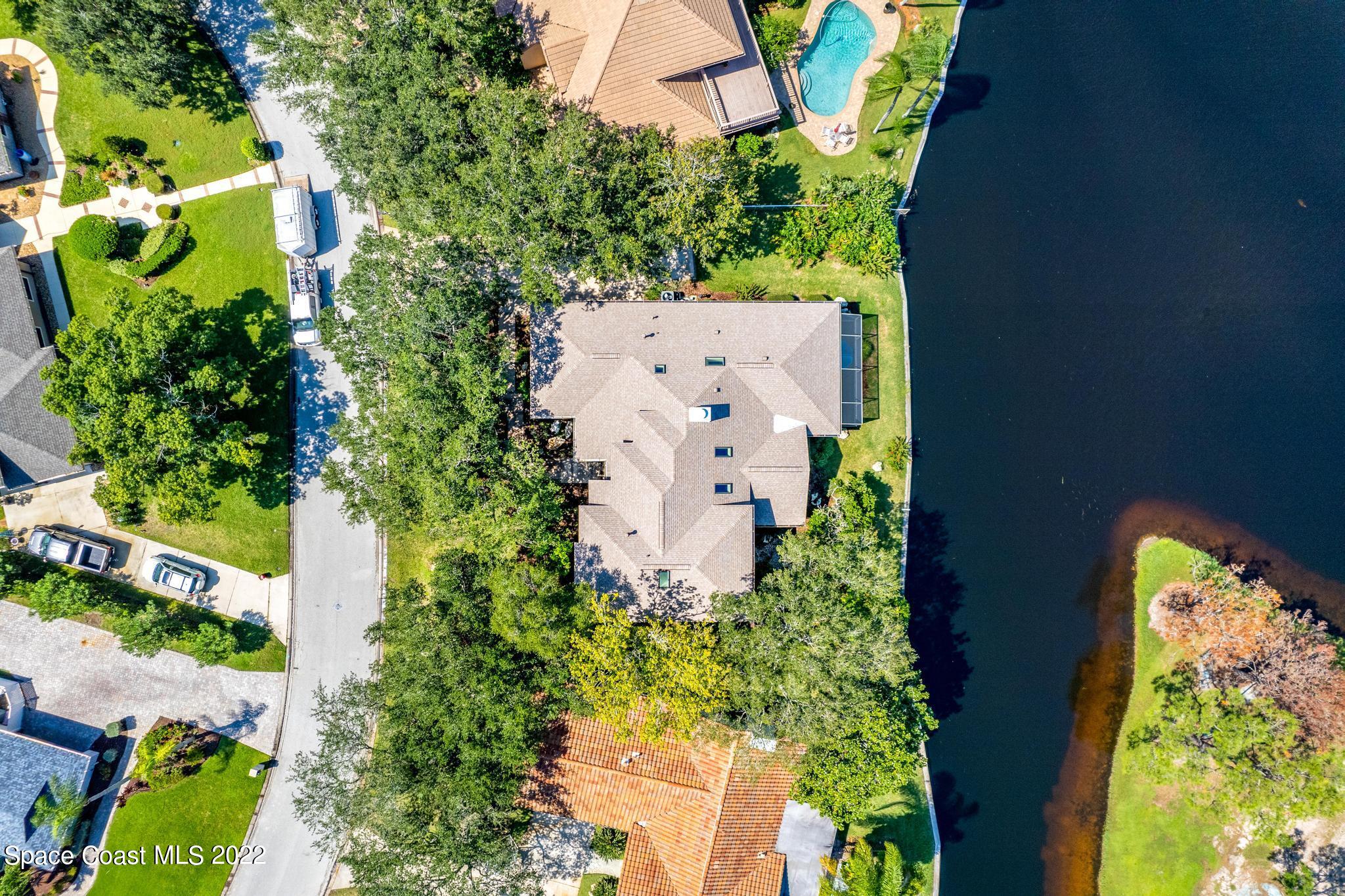 750 Kerry Downs Circle Melbourne, FL 32940 - Photo 32 of 34 an aerial view of a house with a yard and garden