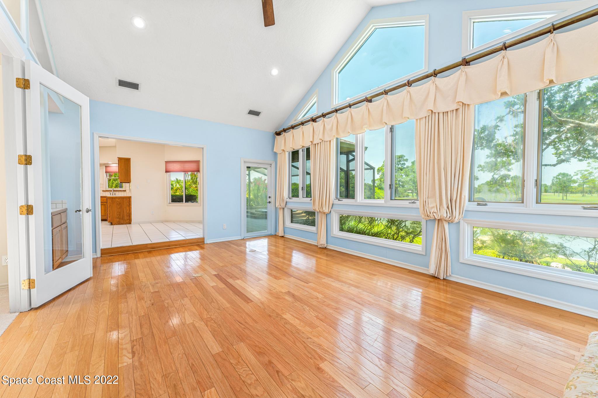 750 Kerry Downs Circle Melbourne, FL 32940 - Photo 6 of 34 a view of an empty room with wooden floor and doors
