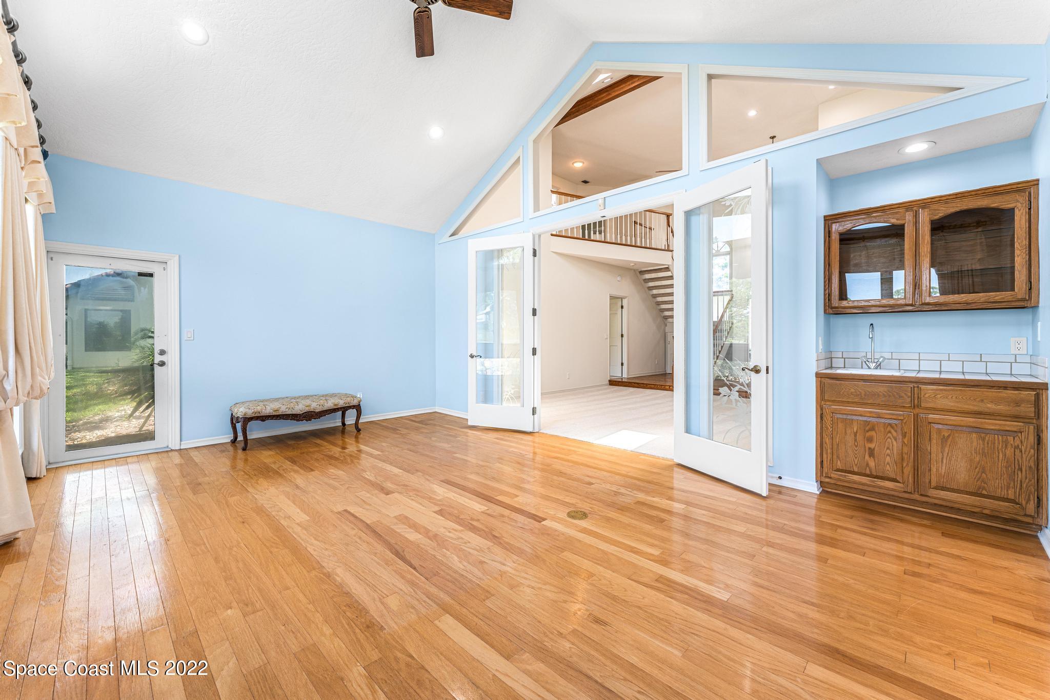 750 Kerry Downs Circle Melbourne, FL 32940 - Photo 7 of 34 a view of an empty room with window and wooden floor