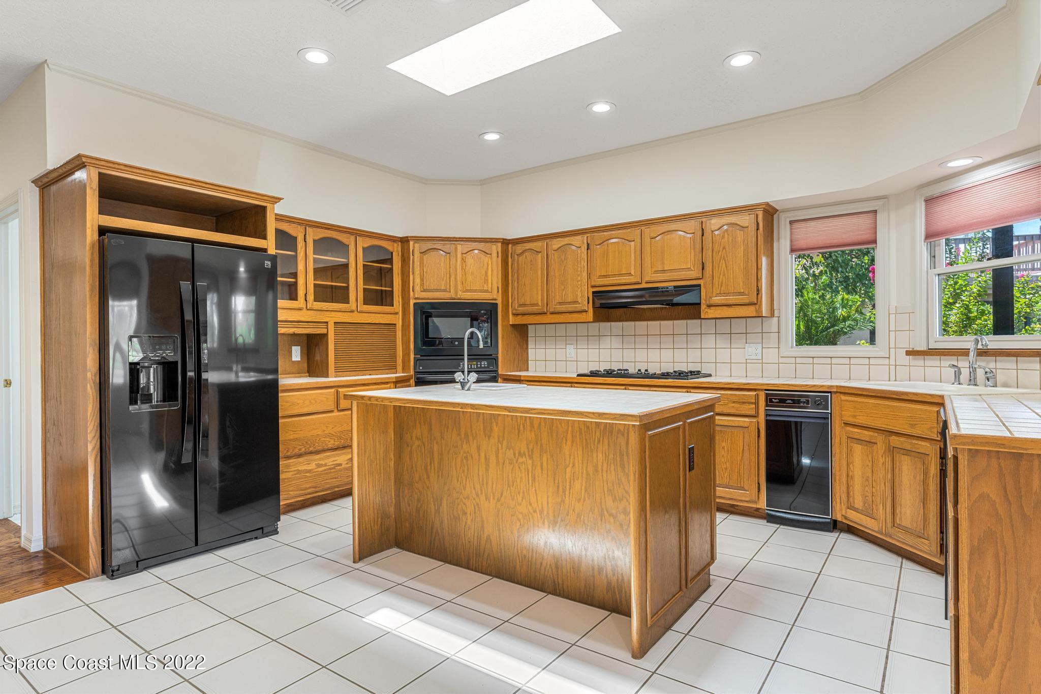 750 Kerry Downs Circle Melbourne, FL 32940 - Photo 8 of 34 a kitchen with stainless steel appliances granite countertop a refrigerator and a sink
