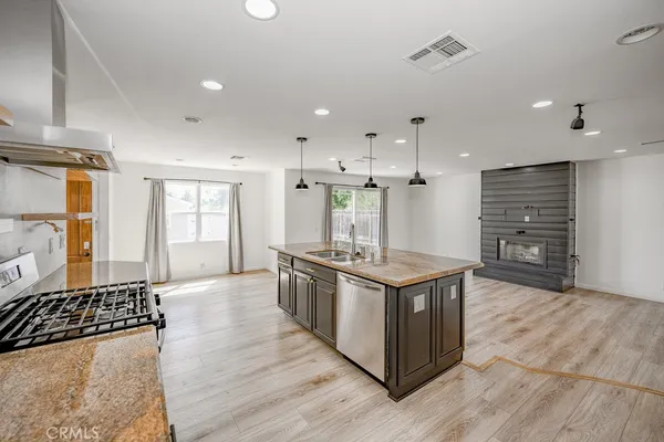 a view of empty room with wooden floor and window