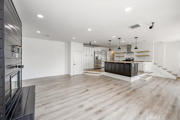 a kitchen with a stove and a wooden floors