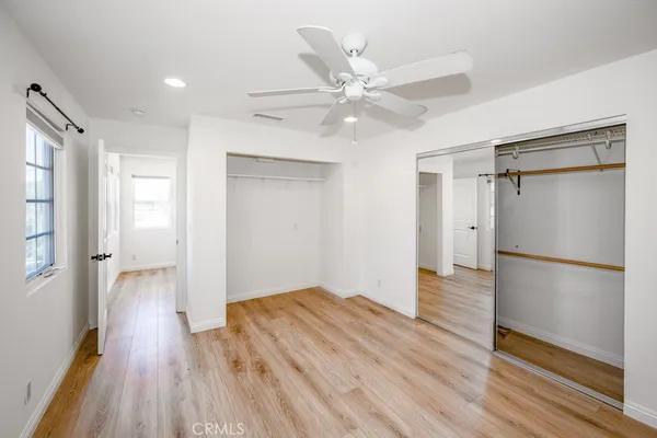a large kitchen with a lot of counter space and wooden floor