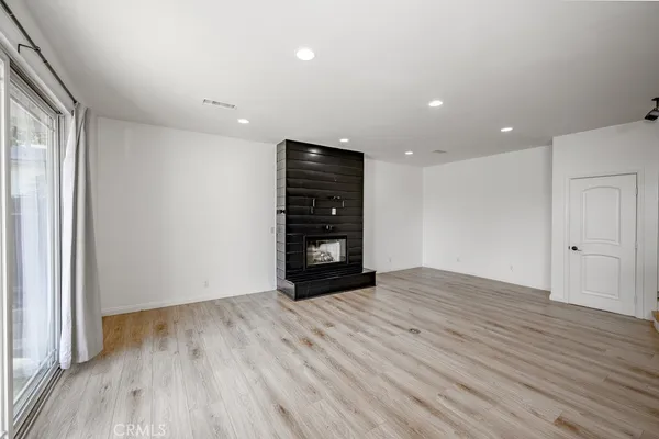 a view of a house with a tub chairs and a fire pit
