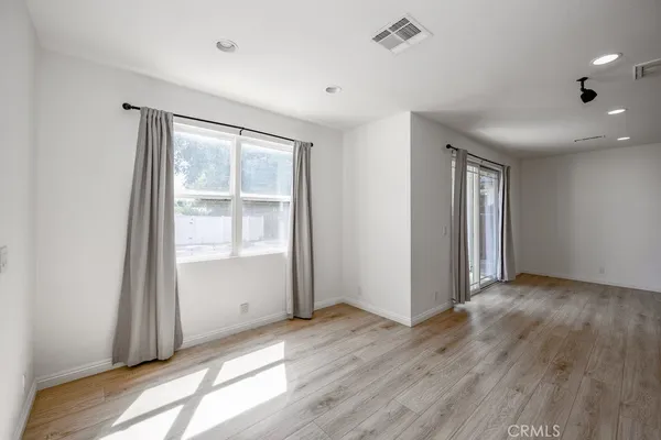 a large kitchen with stainless steel appliances kitchen island a large counter top and a stove top oven
