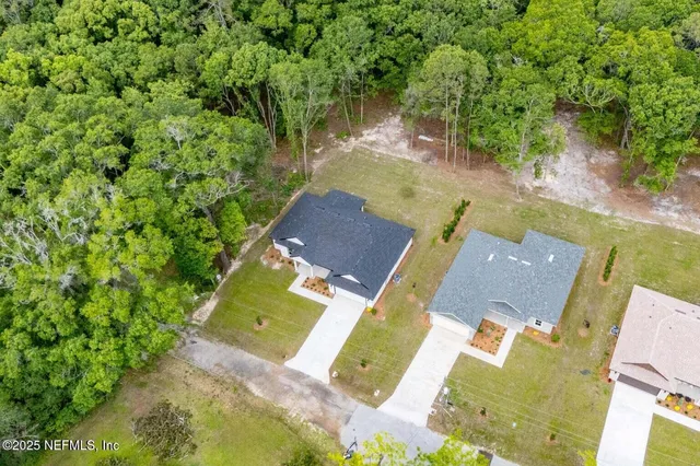 an aerial view of a house with a yard