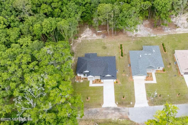 an aerial view of a house with a yard basket ball court