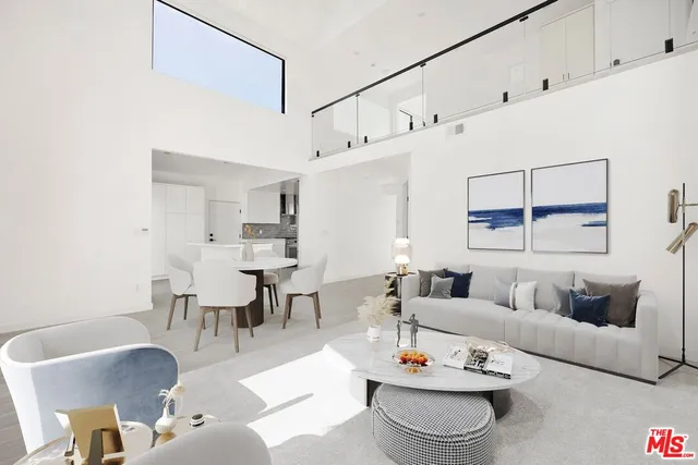 a living room with furniture kitchen view and a dining table