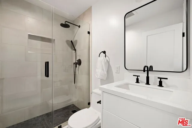 a bathroom with a sink toilet and shower
