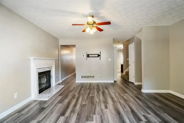 wooden floor in an empty room with a fireplace