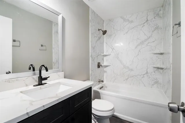 a bathroom with a sink a toilet and a bathtub