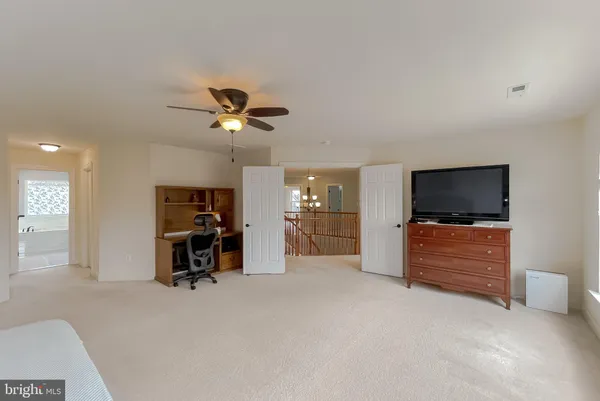 a view of a livingroom with furniture and a flat screen tv