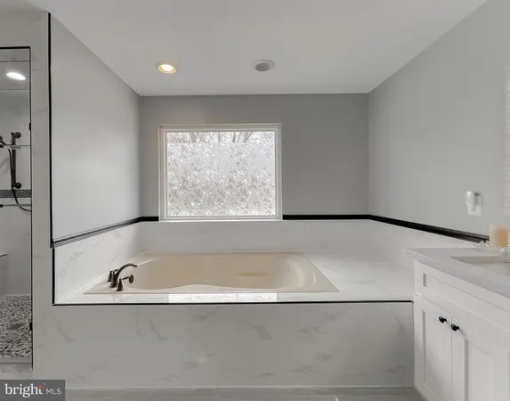 a bathroom with a bathtub and a shower