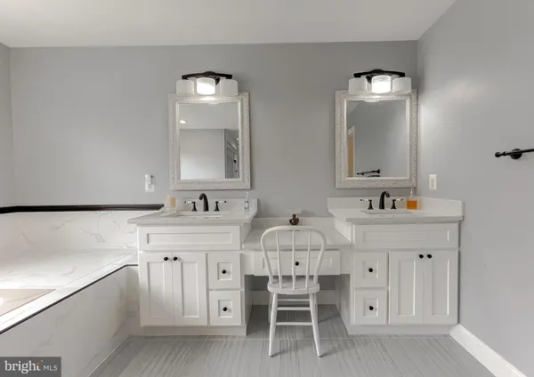 a bathroom with a double vanity sink mirror and