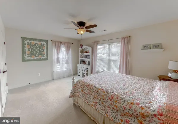 a bedroom with a large bed closet and a window