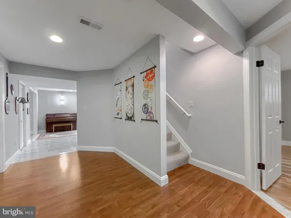 a view of a livingroom with wooden floor and staircase