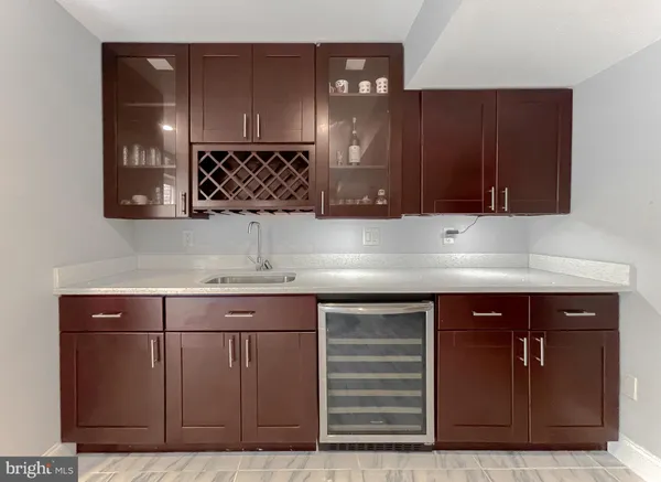 a kitchen with a sink cabinets and wooden floor