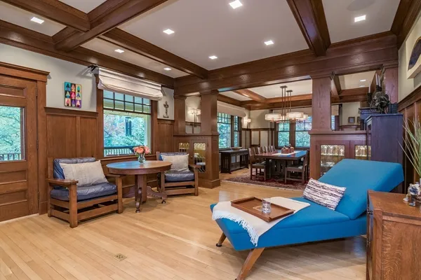 a living room with furniture a rug and a piano