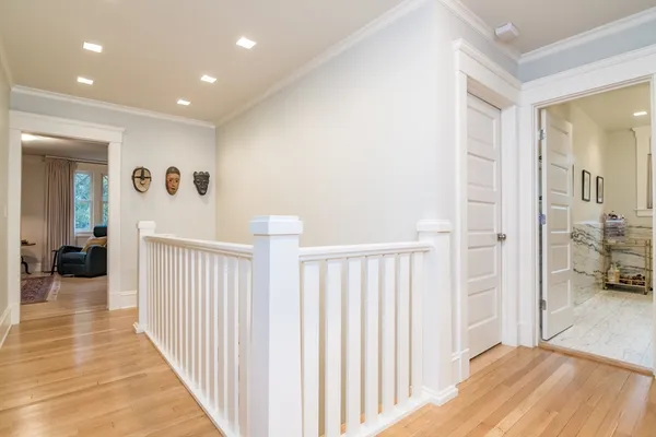 a view of a hallway with a livingroom and a bathroom