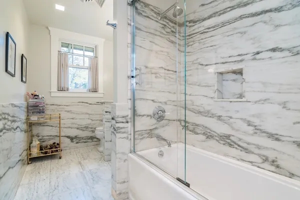 a bathroom with a bathtub and a shower
