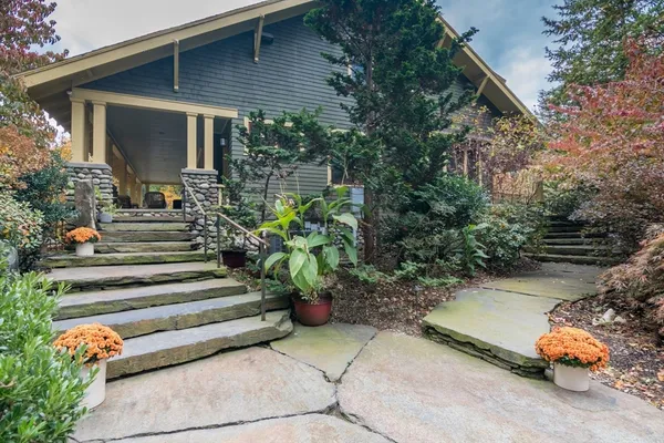 a view of a house with backyard sitting area and garden