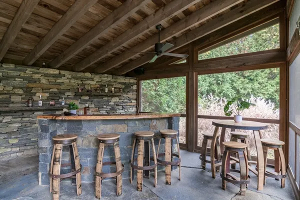 a wooden table and chairs in a balcony