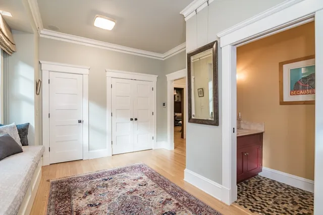 a view of a bedroom with wooden floor and cabinet