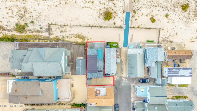 an aerial view of residential houses with outdoor space and parking
