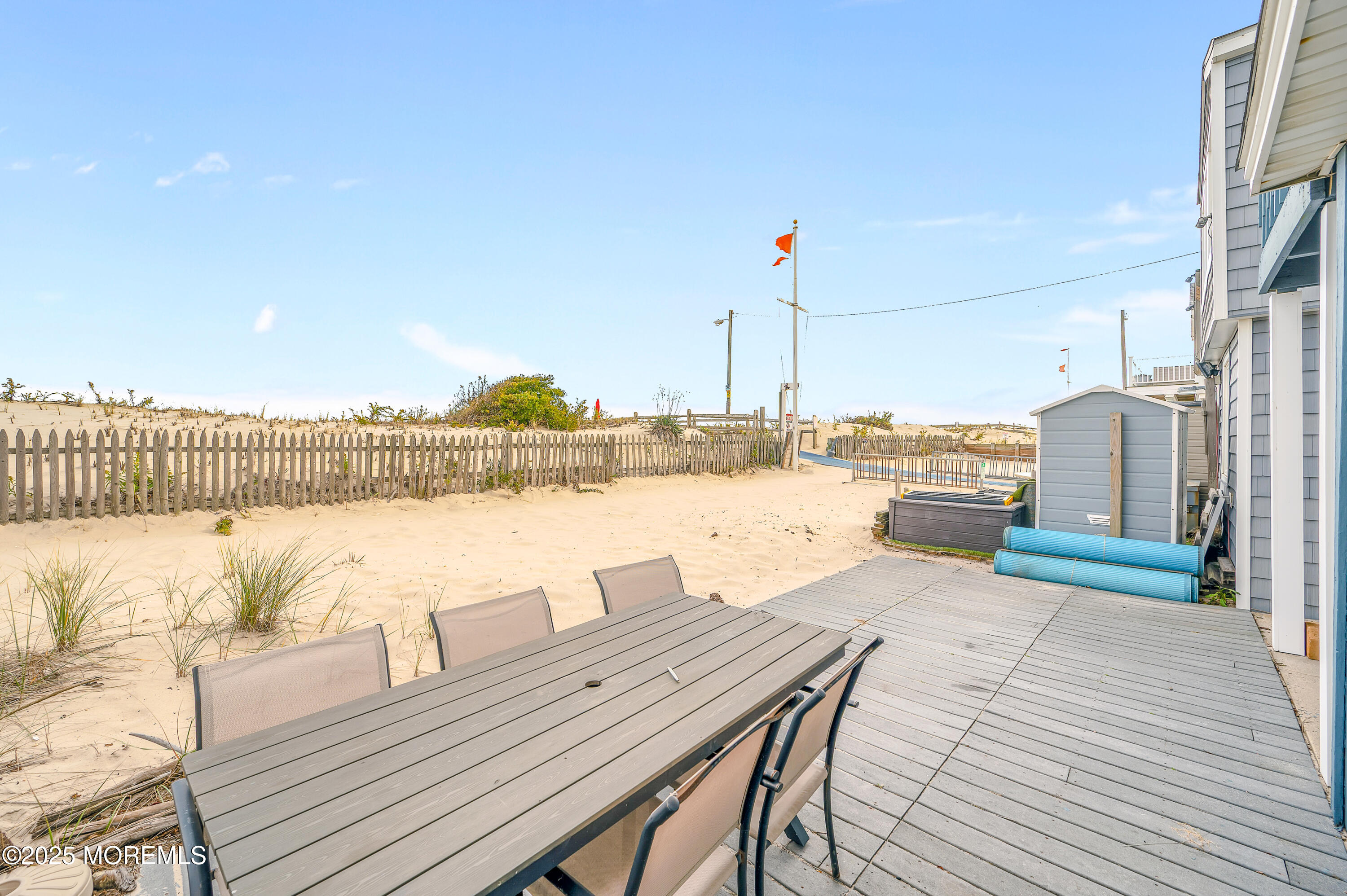 63 East Rutherford Lane Lavallette, NJ 08735 - Photo 26 of 33 a view of a lake with couches and wooden floor