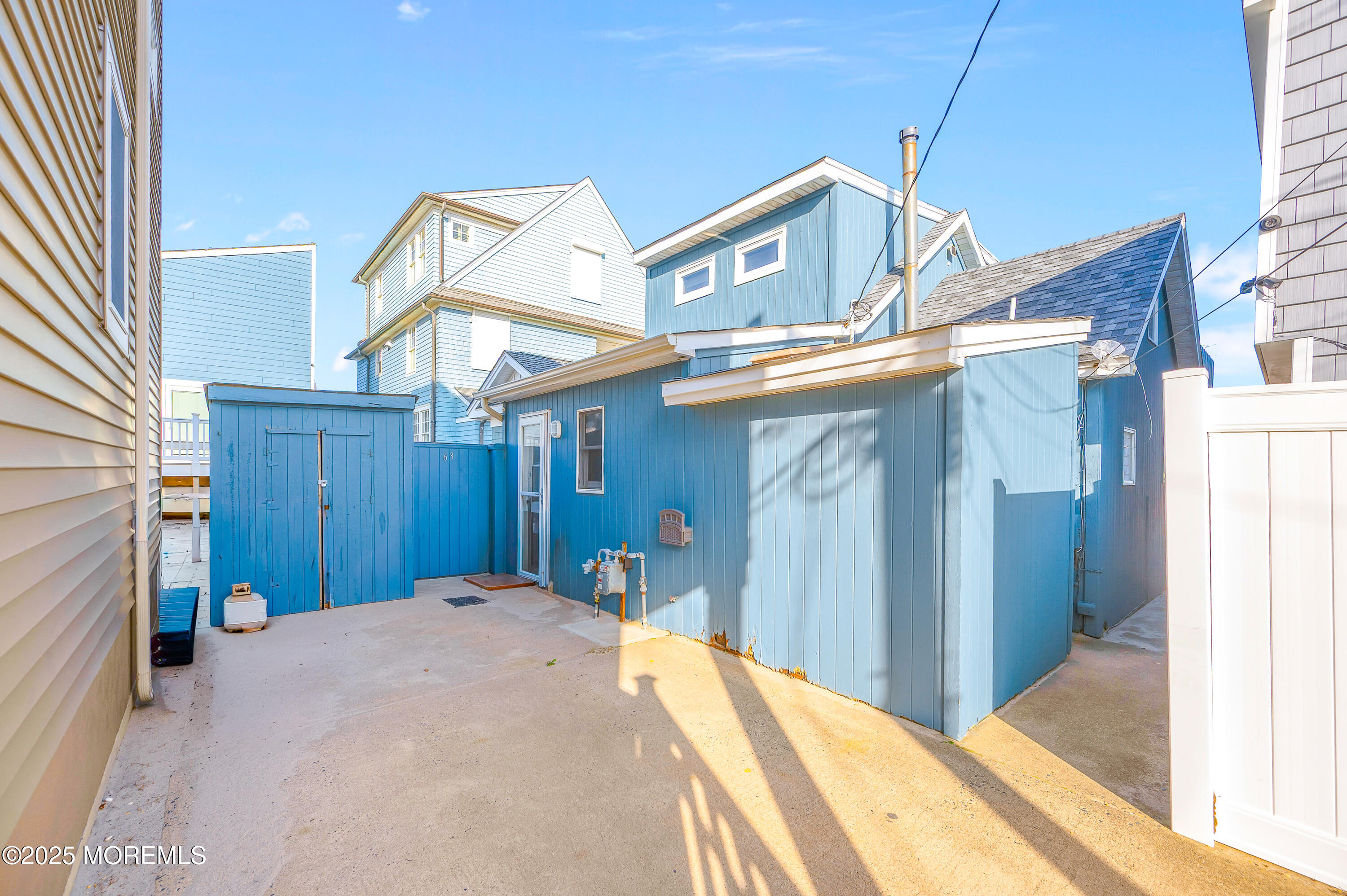 63 East Rutherford Lane Lavallette, NJ 08735 - Photo 8 of 33 a view of a house with a small backyard