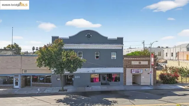 a front view of a building with a yard