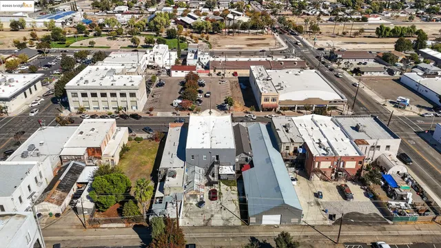 a aerial view of a house with a yard and balcony