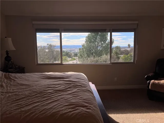 a bed sitting in a bedroom next to a window