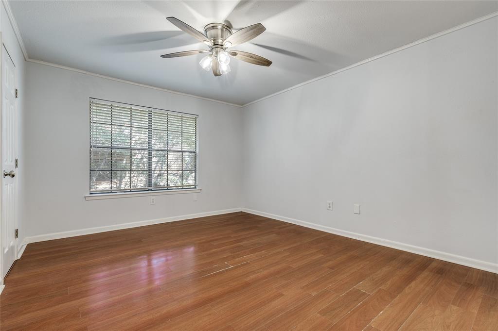5626 Preston Oaks Road, Unit 42B Dallas, TX 75254 - Photo 16 of 25 wooden floor in an empty room with a window