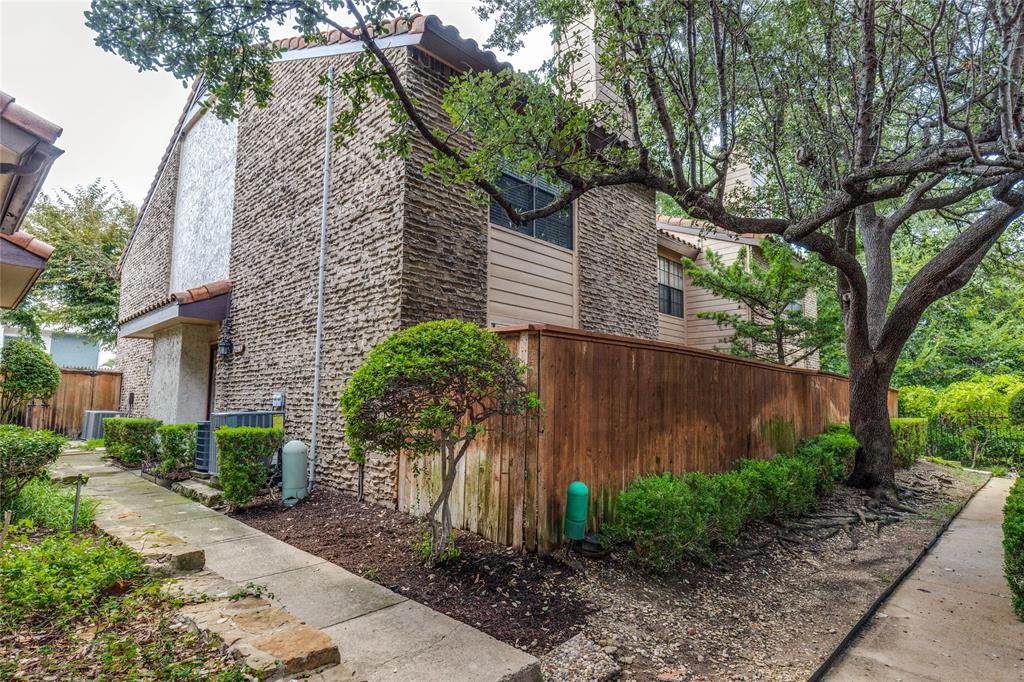 5626 Preston Oaks Road, Unit 42B Dallas, TX 75254 - Photo 2 of 25 a front view of a house with a garden