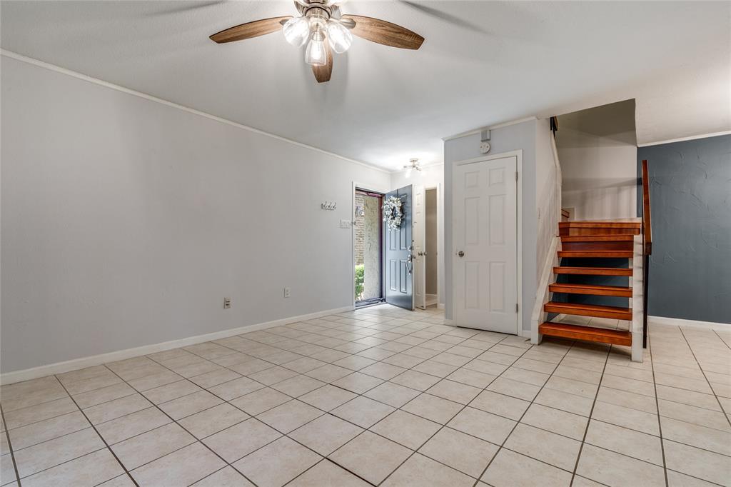 5626 Preston Oaks Road, Unit 42B Dallas, TX 75254 - Photo 5 of 25 an empty room with staircase and view of a bathroom