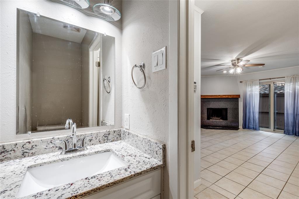 5626 Preston Oaks Road, Unit 42B Dallas, TX 75254 - Photo 6 of 25 a en suite bathroom with a granite countertop sink and a mirror