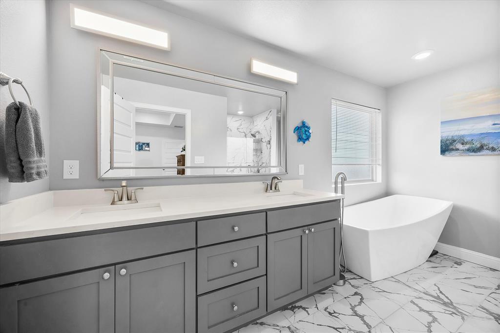 2808 Rodeo Drive Quinlan, TX 75474 - Photo 32 of 39 a bathroom with a double vanity sink mirror and bathtub