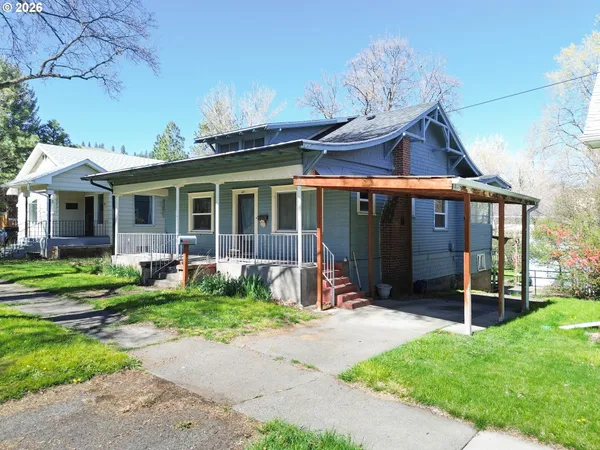 a front view of a house with garden and porch