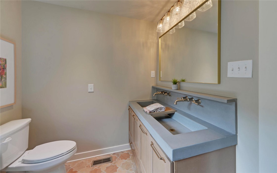 398 Hidden Point Road Hartwell, GA 30643 - Photo 11 of 46 This bathroom features a sleek double vanity and unique tiled flooring.